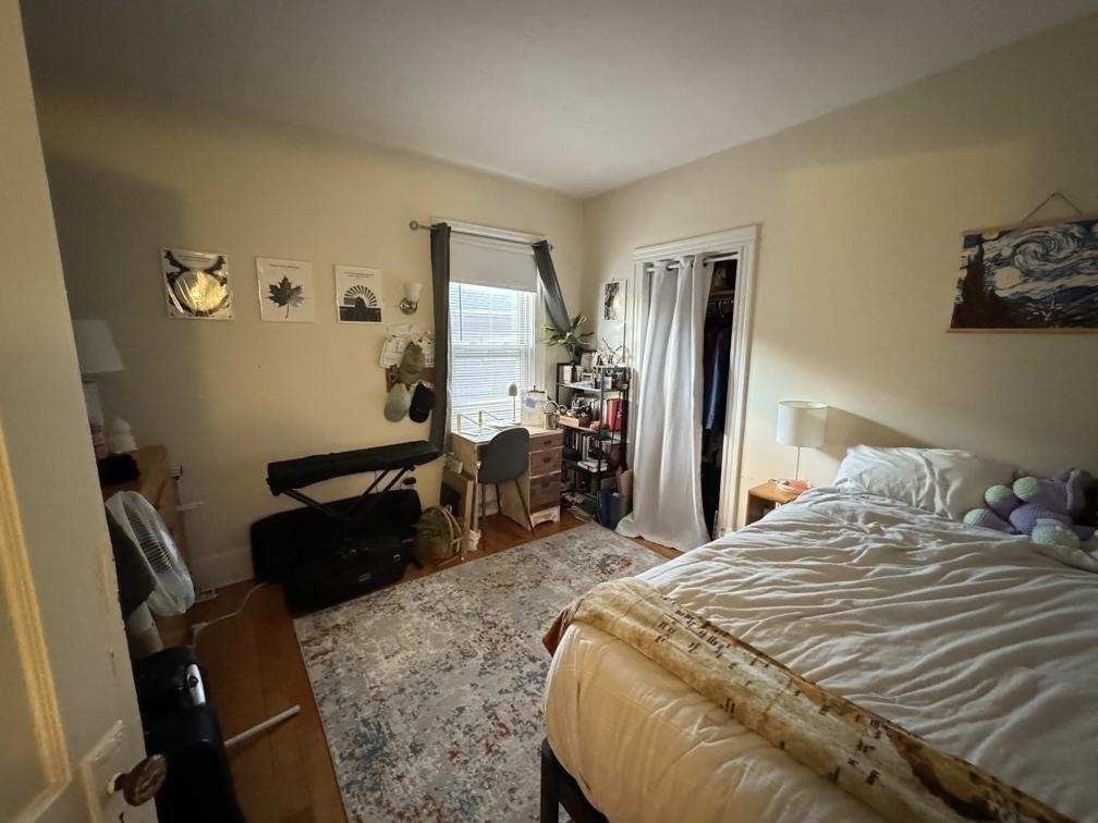 28 Sunset Road, Unit 1 Somerville, MA 02144 - Photo 10 of 15 a bedroom with a bed and wooden floor