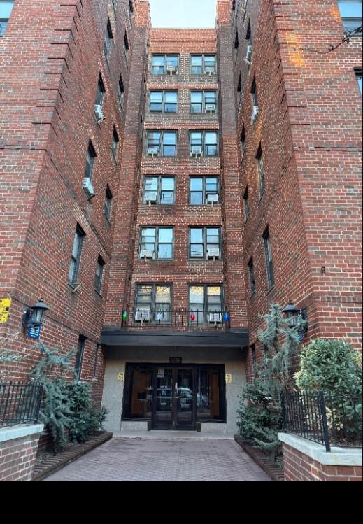 37-30 83rd Street, Unit 2M Queens, NY 11372 - Photo 1 of 20 a view of a building with a yard and potted plants
