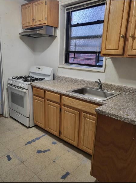 37-30 83rd Street, Unit 2M Queens, NY 11372 - Photo 9 of 20 a kitchen with granite countertop a sink and a stove
