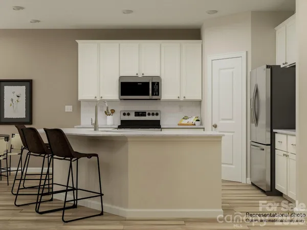 a kitchen with stainless steel appliances a stove a sink a microwave and a refrigerator