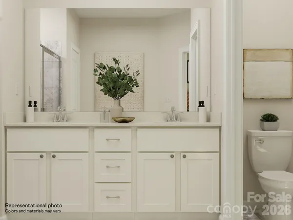 a bathroom with a sink vanity granite toilet and a mirror