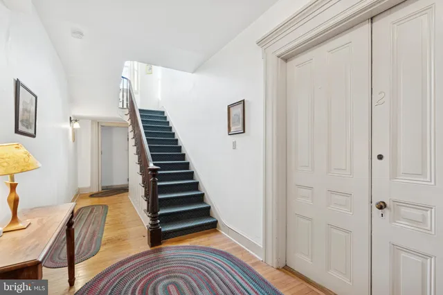 a view of a room with furniture and wooden floor