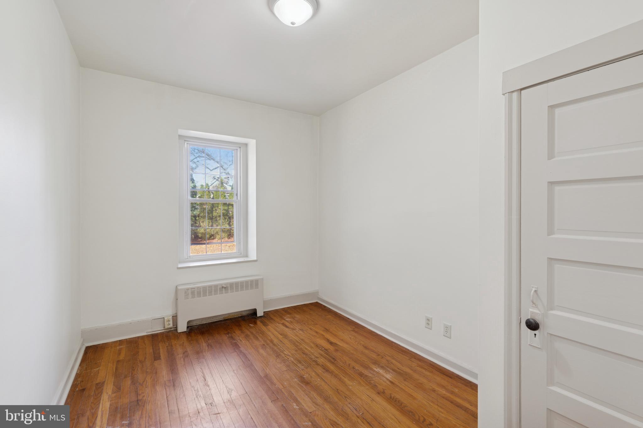 1138 East Schuylkill Road, Unit 2 Pottstown, PA 19465 - Photo 4 of 14 an empty room with wooden floor and windows