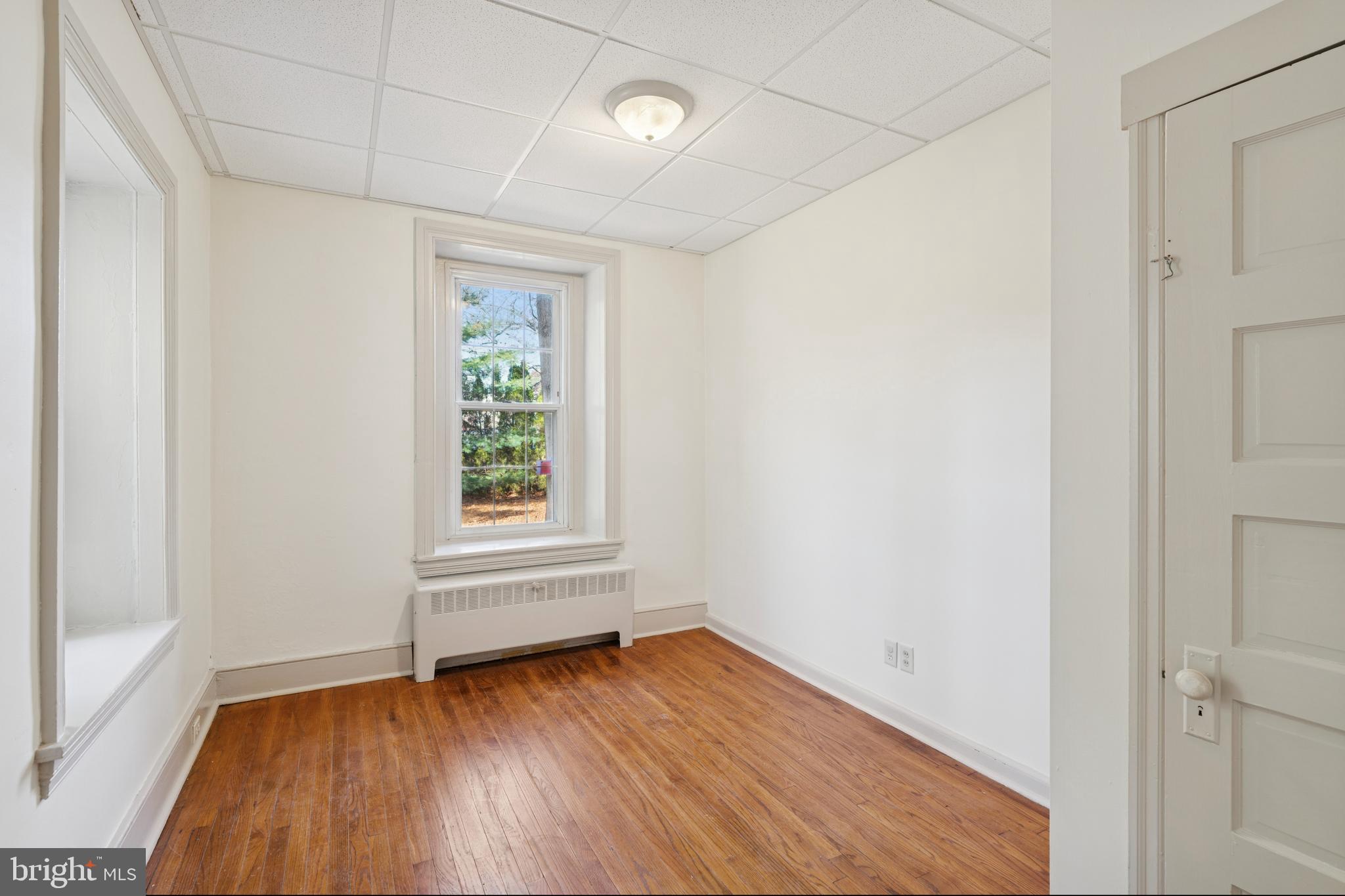 1138 East Schuylkill Road, Unit 2 Pottstown, PA 19465 - Photo 5 of 14 an empty room with wooden floor and windows