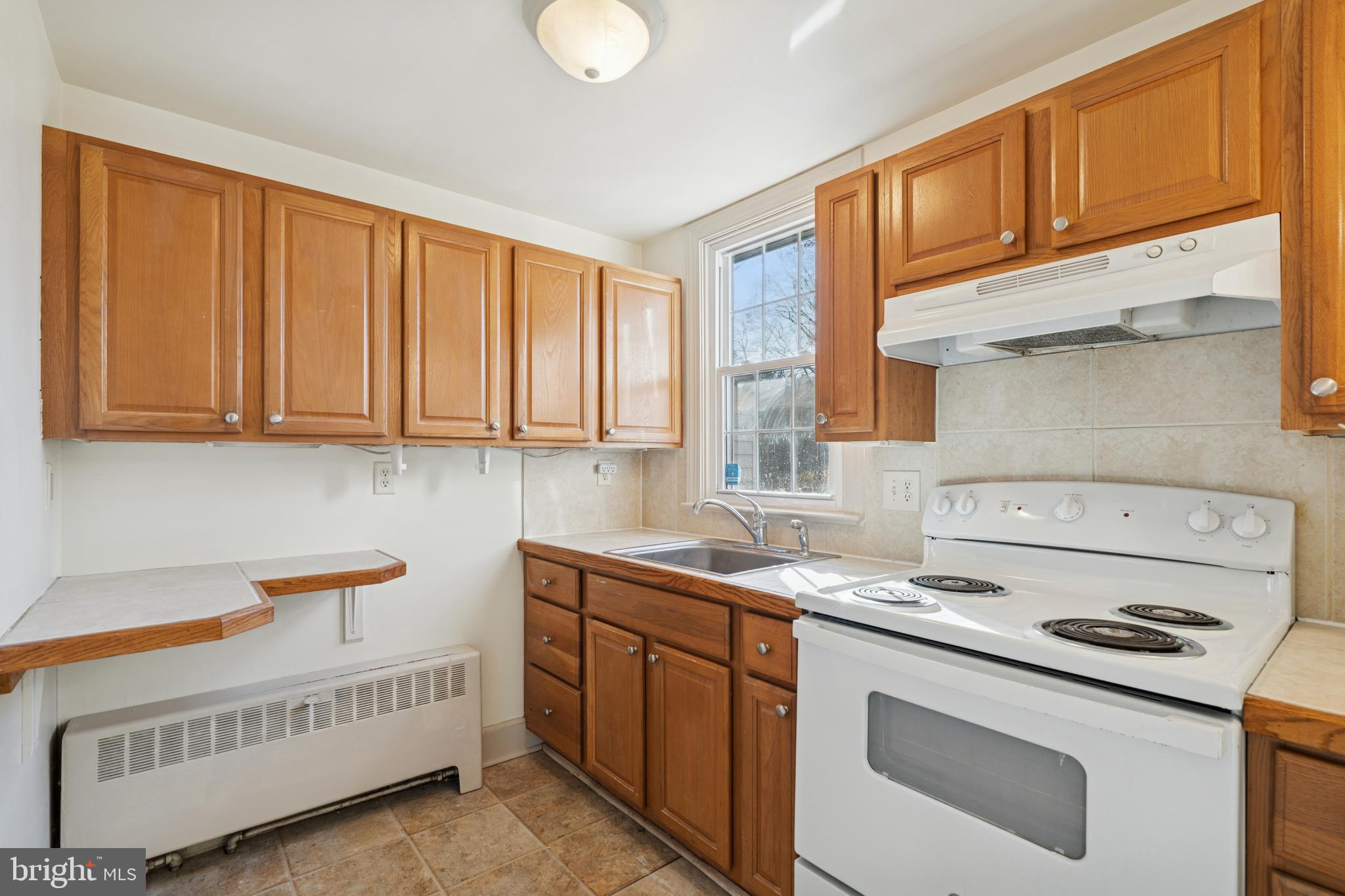 1138 East Schuylkill Road, Unit 2 Pottstown, PA 19465 - Photo 8 of 14 a kitchen that has a sink and a stove
