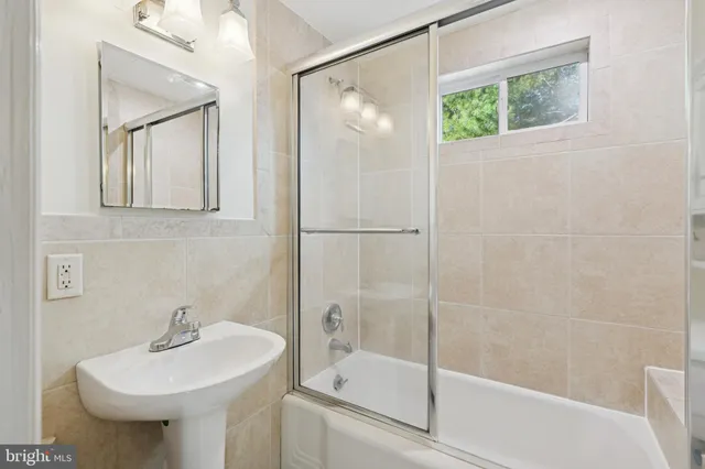 a bathroom with a sink a mirror and a shower