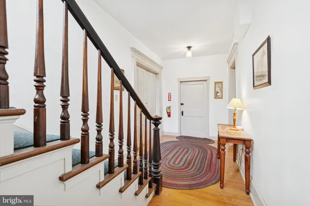 a view of entryway with wooden floor and stairs