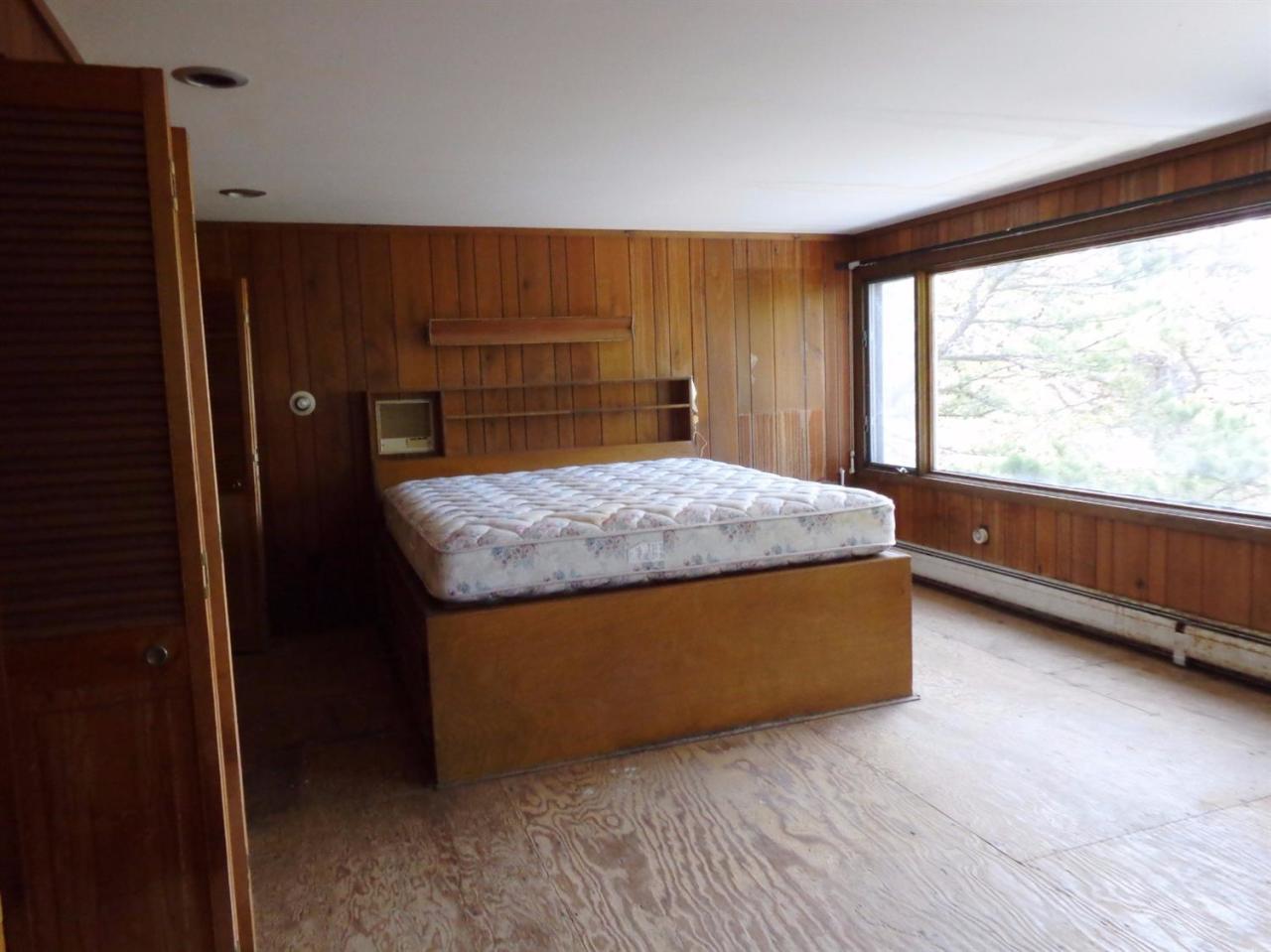 45 Uplands Drive Wellfleet, MA 02667 - Photo 17 of 35 a living room with a bed furniture and a large window
