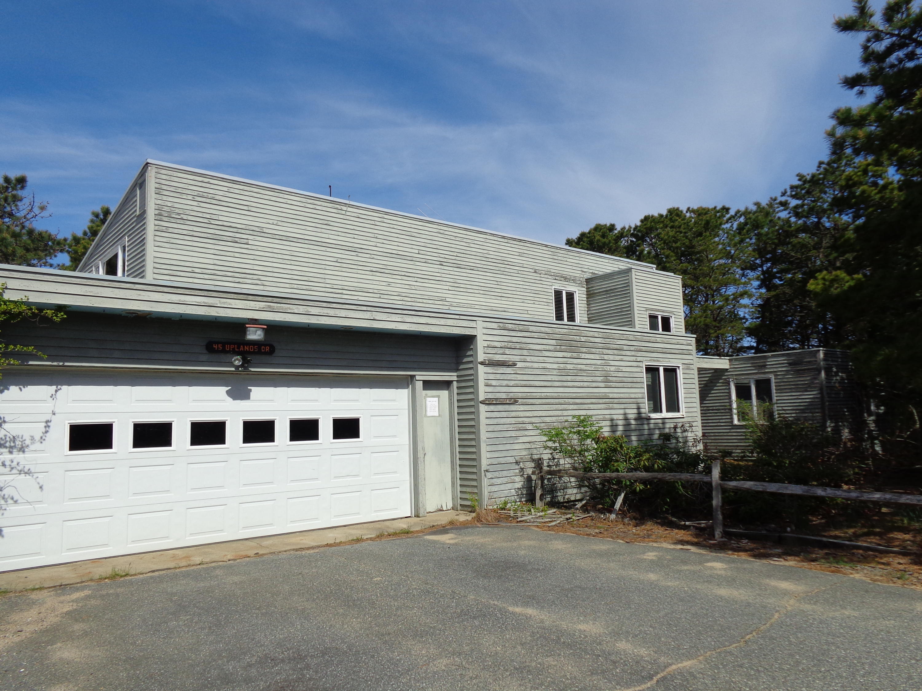 45 Uplands Drive Wellfleet, MA 02667 - Photo 2 of 35 a front view of a house with a garage