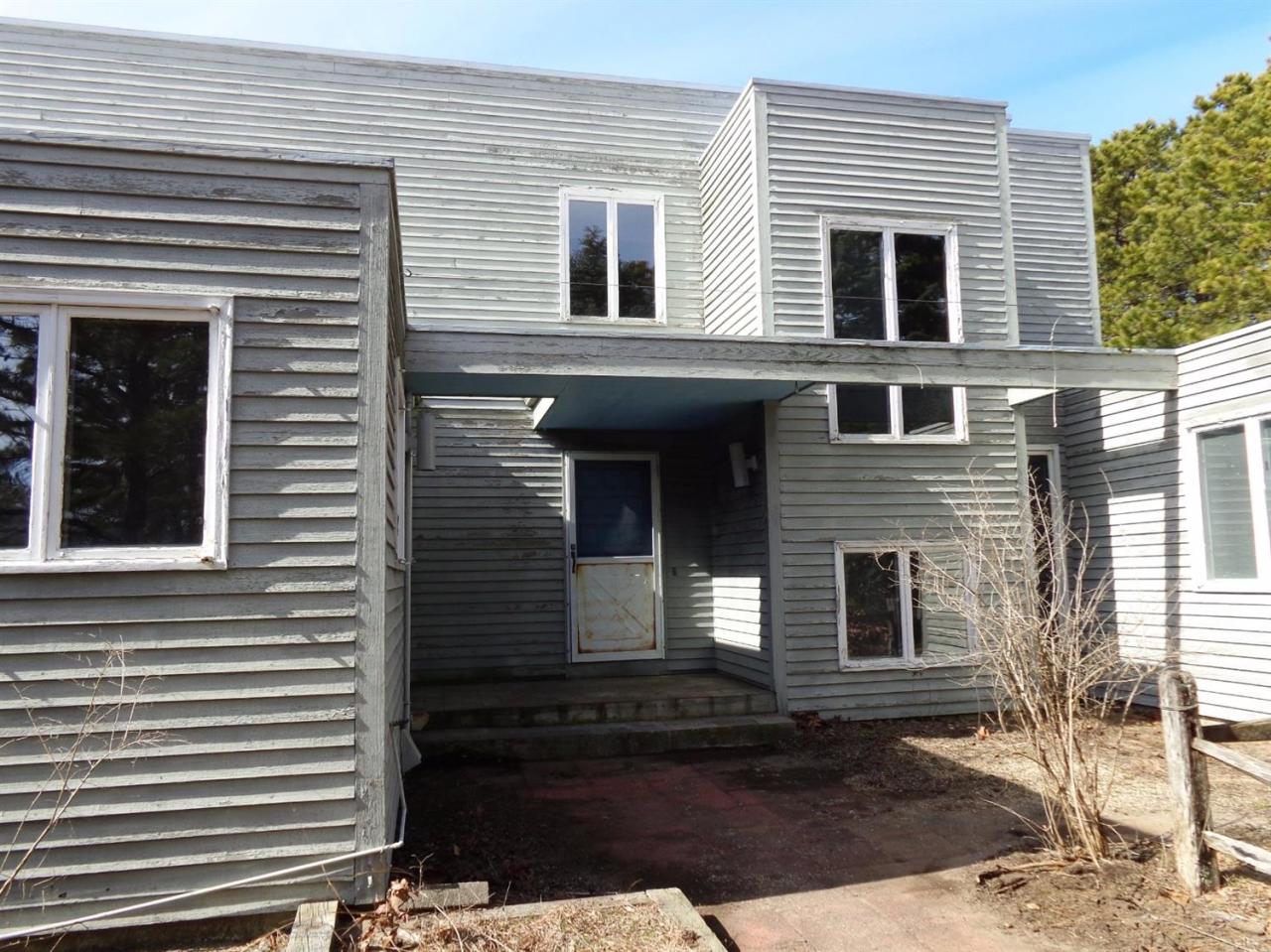 45 Uplands Drive Wellfleet, MA 02667 - Photo 32 of 35 a view of a house with more windows and a yard