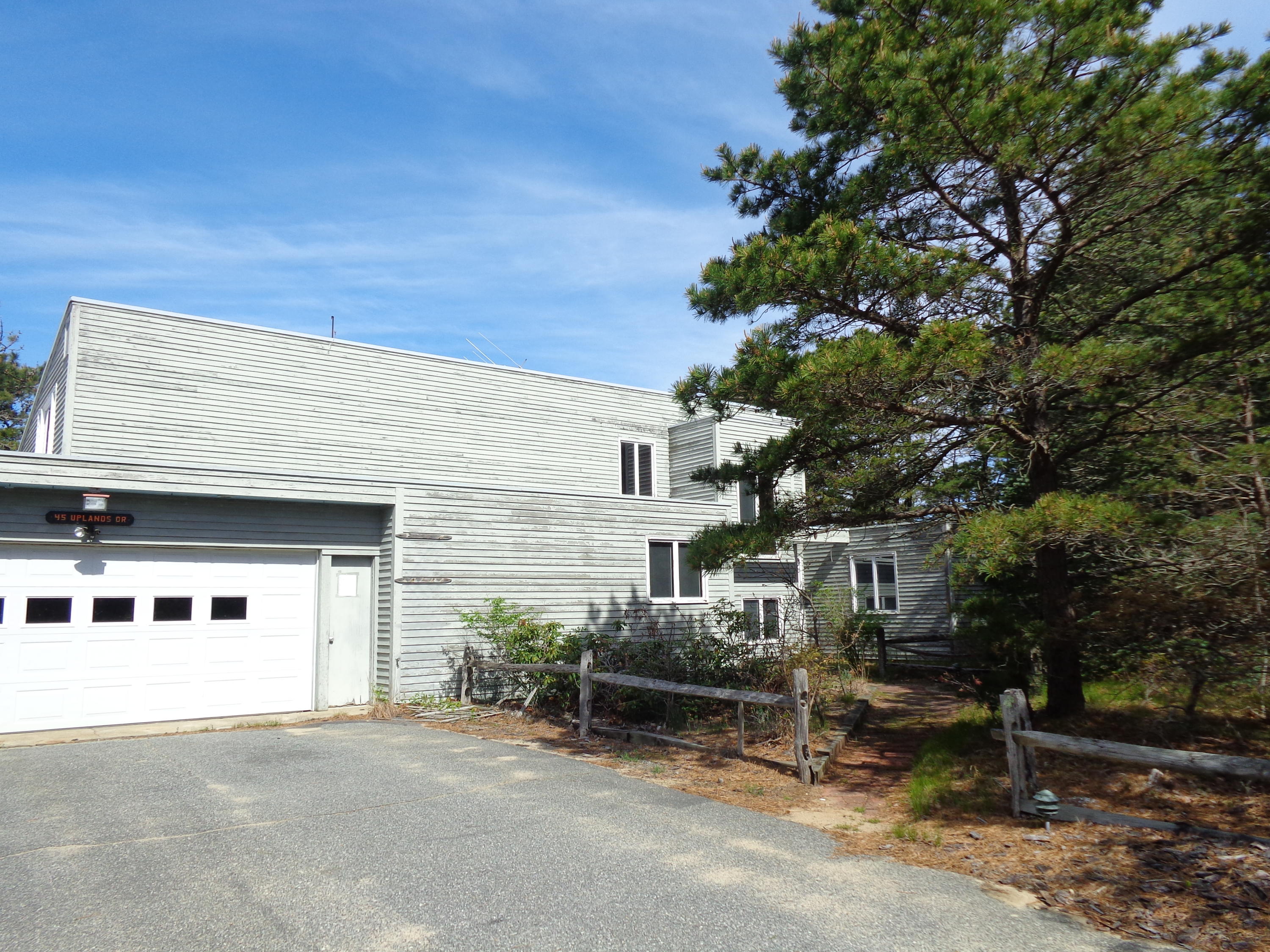 45 Uplands Drive Wellfleet, MA 02667 - Photo 35 of 35 a white house that has a tree in front of it