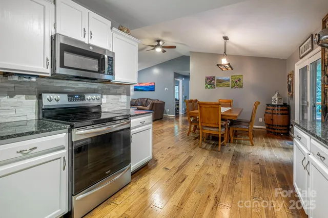 a dining room with furniture a chandelier and wooden floor