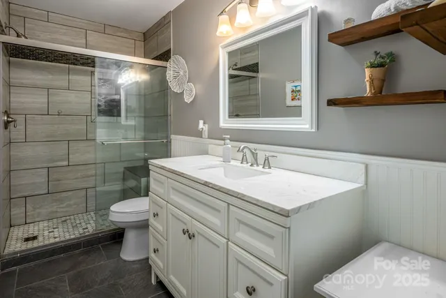 a living room with furniture a flat screen tv and a floor to ceiling window