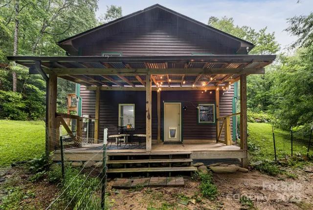 a view of a chairs and table in patio with a backyard