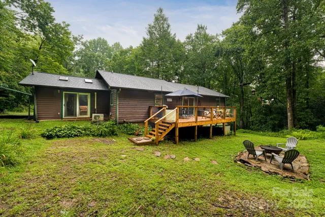 a view of a house with backyard sitting area and garden