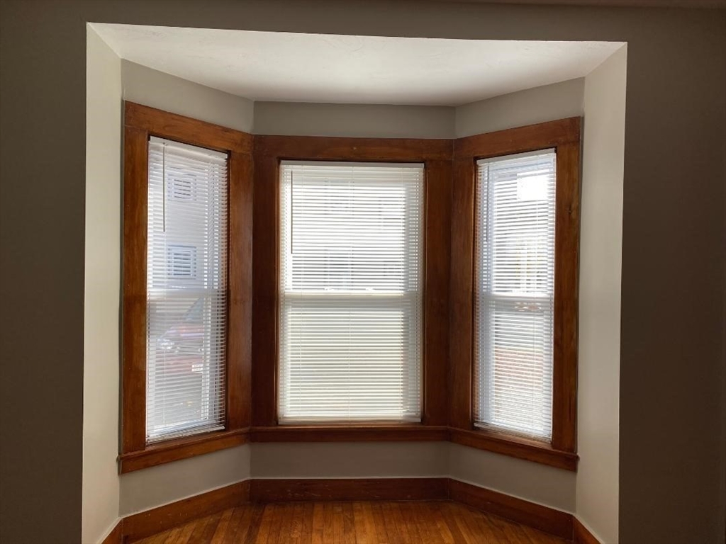 16 Ruggles Street, Unit 1 Westborough, MA 01581 - Photo 11 of 22 a view of an empty room with wooden floor and a window