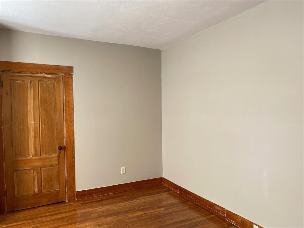 16 Ruggles Street, Unit 1 Westborough, MA 01581 - Photo 13 of 22 a view of an empty room with wooden floor
