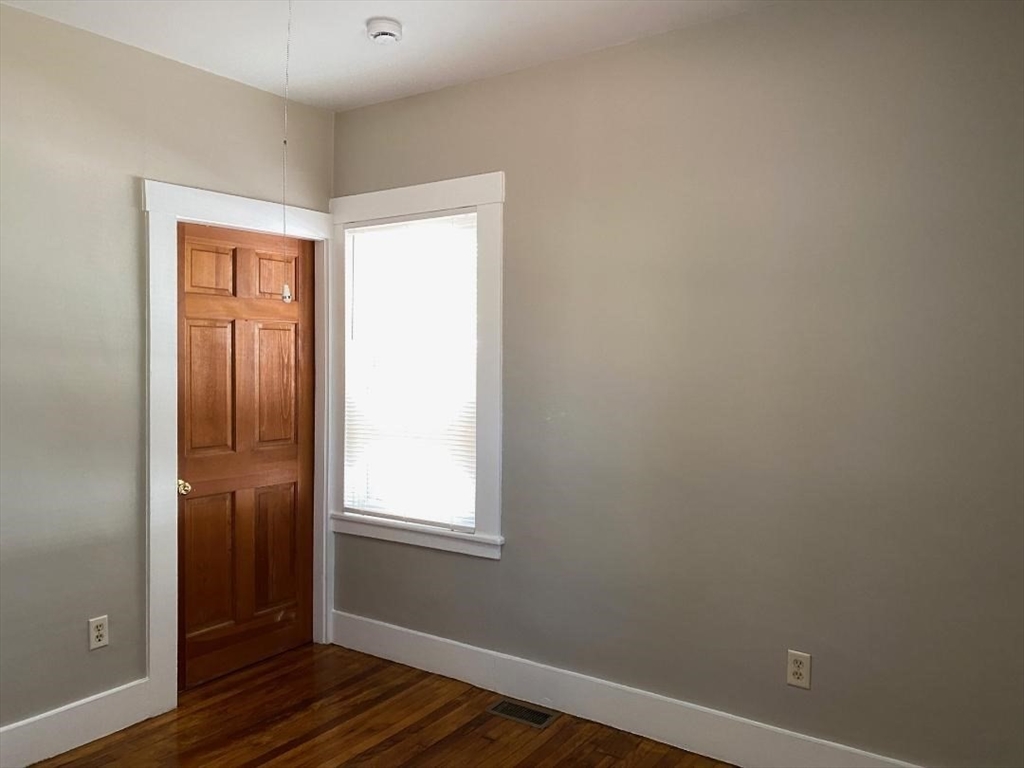 16 Ruggles Street, Unit 1 Westborough, MA 01581 - Photo 17 of 22 a view of an empty room with wooden floor and closet