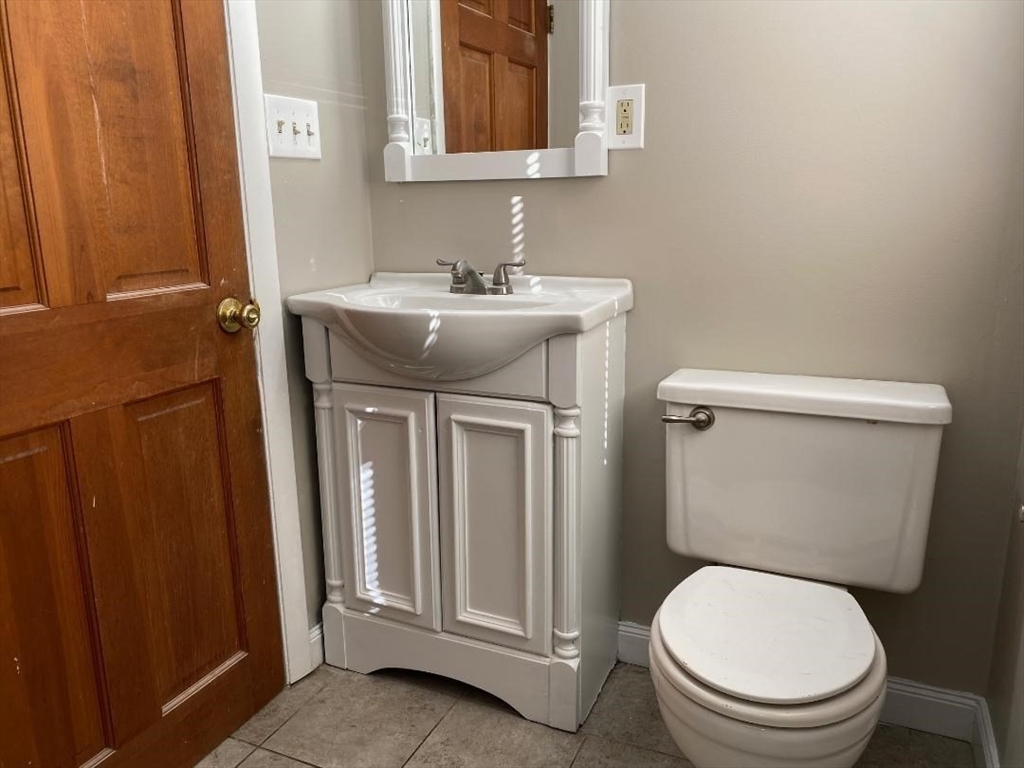 16 Ruggles Street, Unit 1 Westborough, MA 01581 - Photo 19 of 22 a white toilet sitting next to a bathroom sink