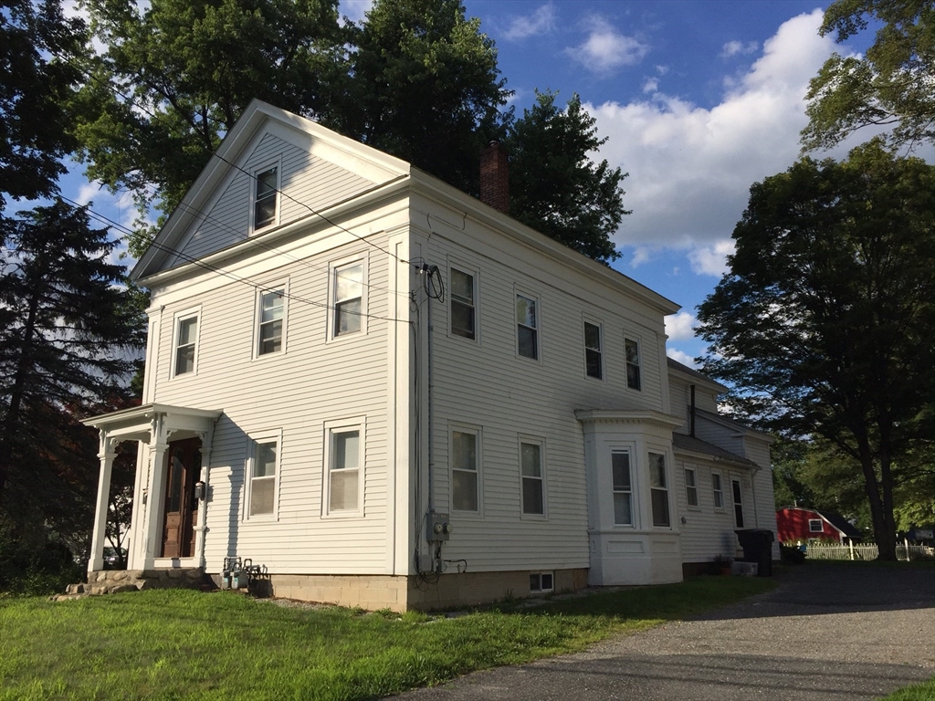 16 Ruggles Street, Unit 1 Westborough, MA 01581 - Photo 21 of 22 a view of a white house next to a yard