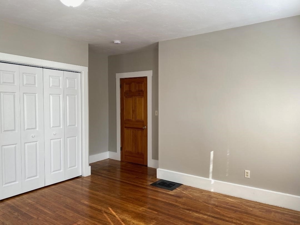 16 Ruggles Street, Unit 1 Westborough, MA 01581 - Photo 10 of 22 a view of an empty room with wooden floor