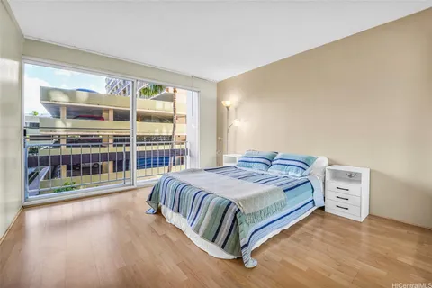 a bedroom with a bed and a large window