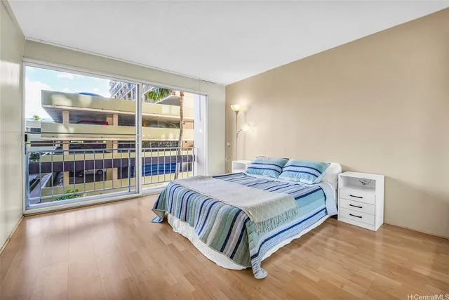 a bedroom with a bed and a large window