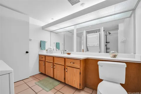 a spacious bathroom with a toilet sink and mirror
