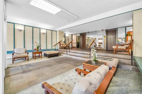 a living room with furniture and large windows