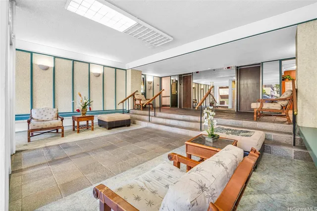 a living room with furniture and large windows