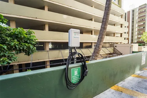a view of a tall building with palm trees
