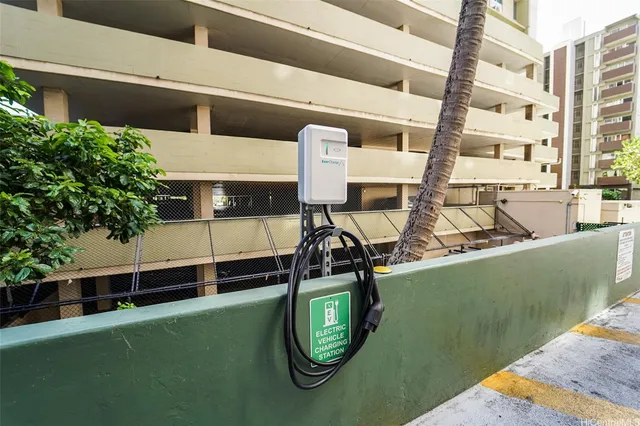 a view of a tall building with palm trees