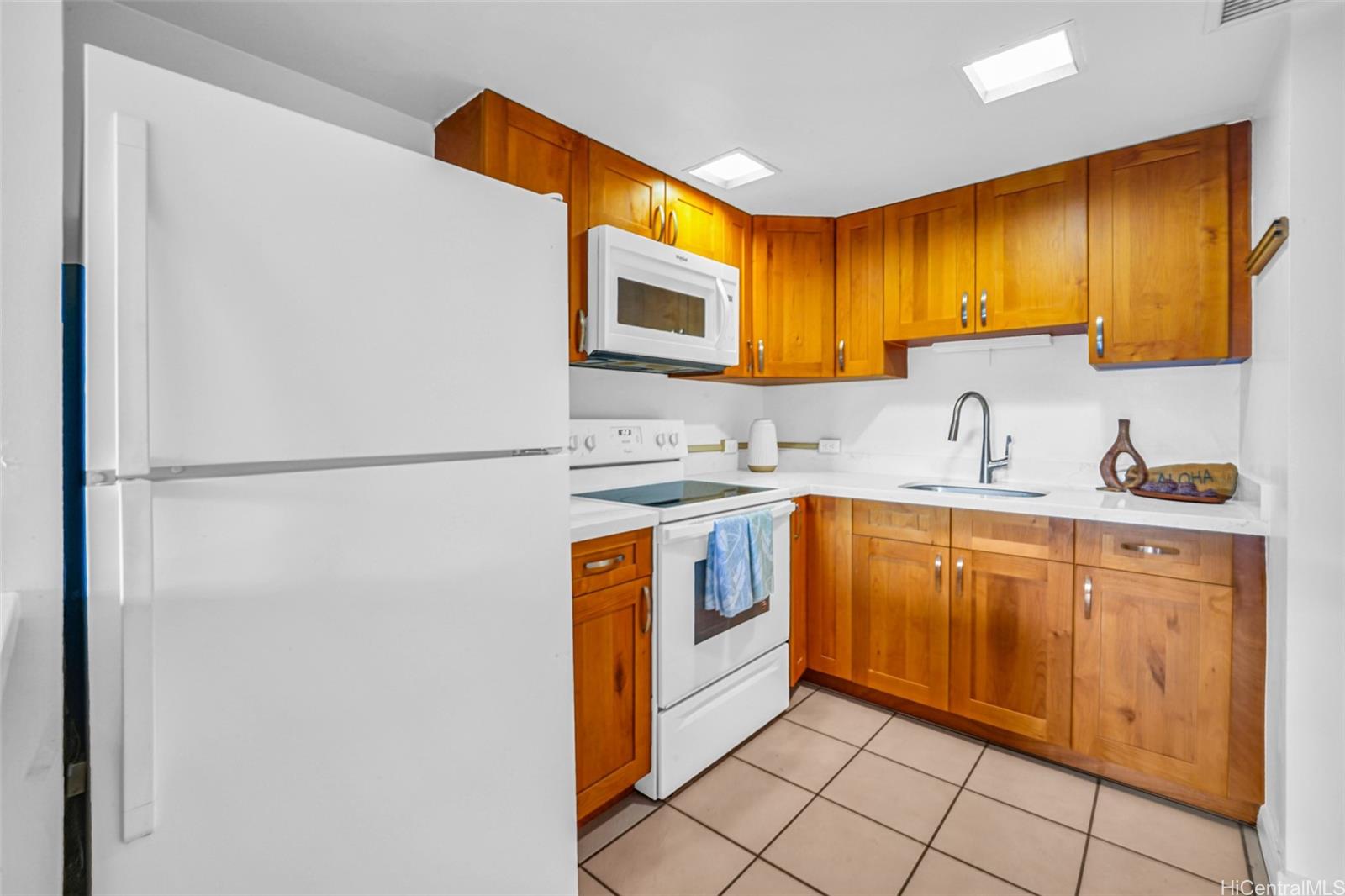 431 Nāhua Street, Unit 309 Honolulu, HI 96815 - Photo 5 of 25 a kitchen with stainless steel appliances granite countertop a stove a sink and a refrigerator