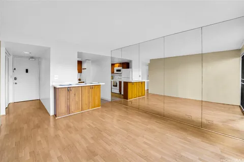 a view of a kitchen with a sink and a refrigerator