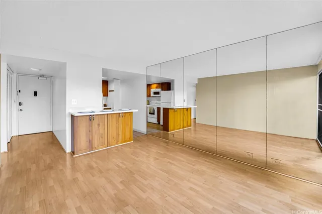 a view of a kitchen with a sink and a refrigerator
