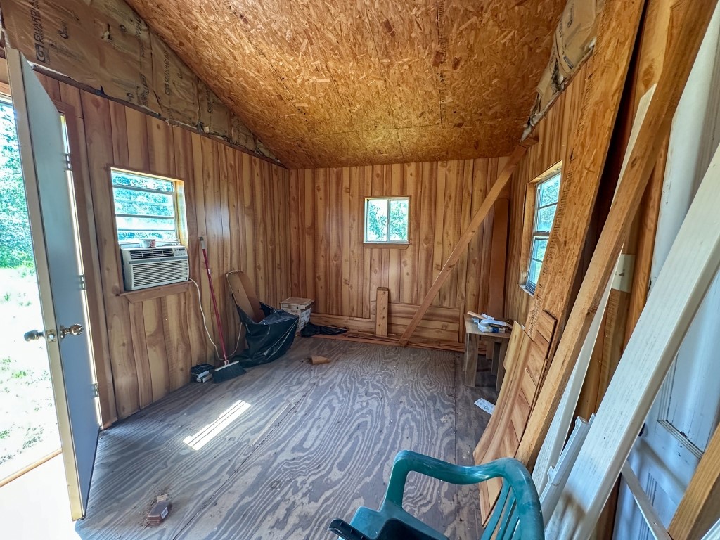 502 Robertson Road Smiley, TX 78159 - Photo 17 of 31 a view of an empty room with wooden floor and a window