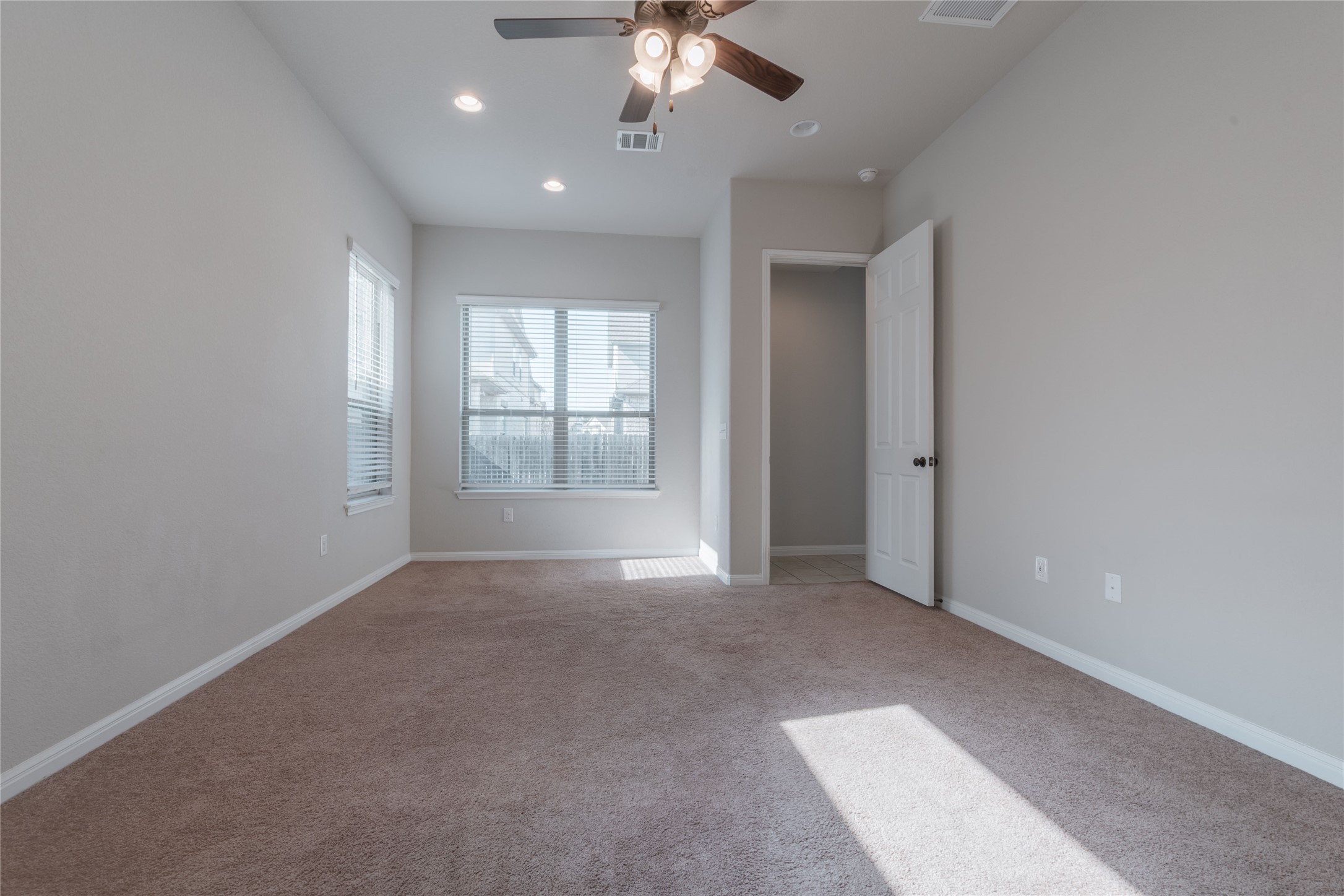 3810 Brushy Creek Road, Unit 77 Cedar Park, TX 78613 - Photo 12 of 33 an empty room with chandelier fan and windows