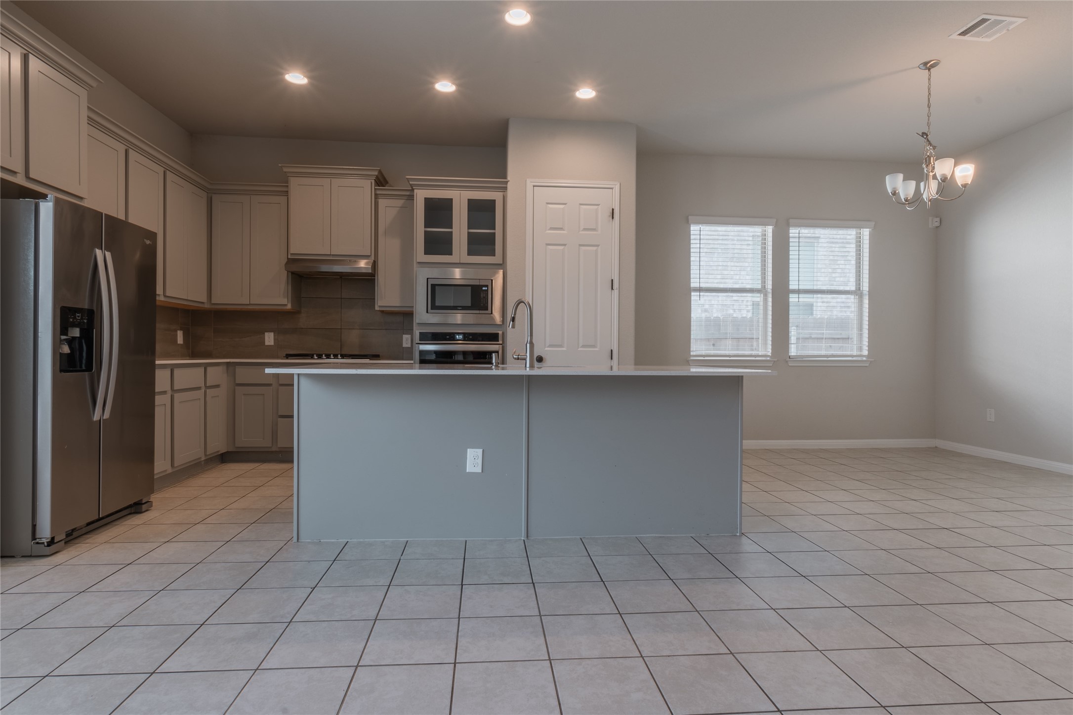 3810 Brushy Creek Road, Unit 77 Cedar Park, TX 78613 - Photo 16 of 33 a kitchen with stainless steel appliances granite countertop a refrigerator a sink dishwasher a stove and white cabinets with wooden floor