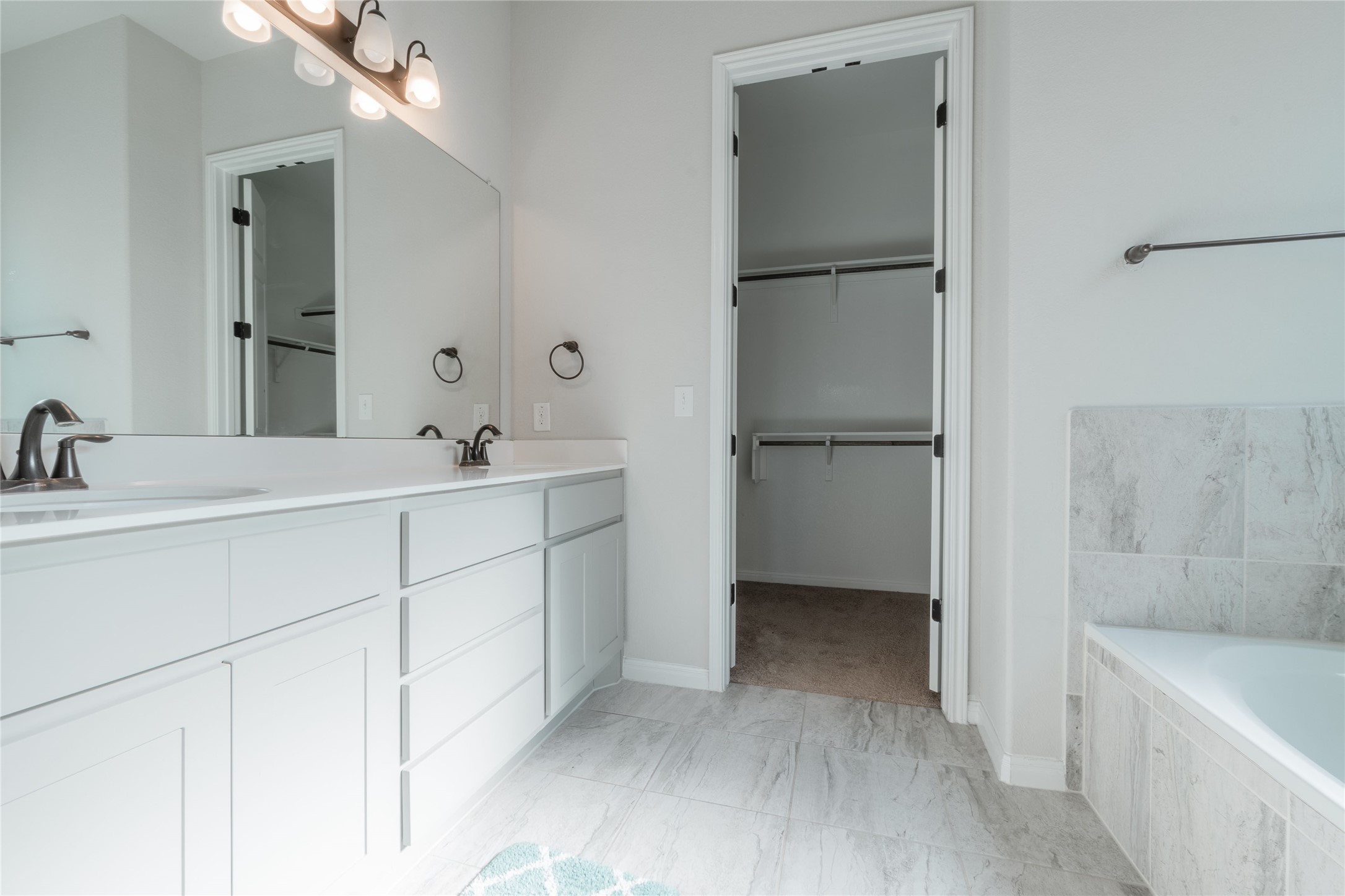 3810 Brushy Creek Road, Unit 77 Cedar Park, TX 78613 - Photo 20 of 33 a bathroom with a double vanity sink a mirror and a bathtub