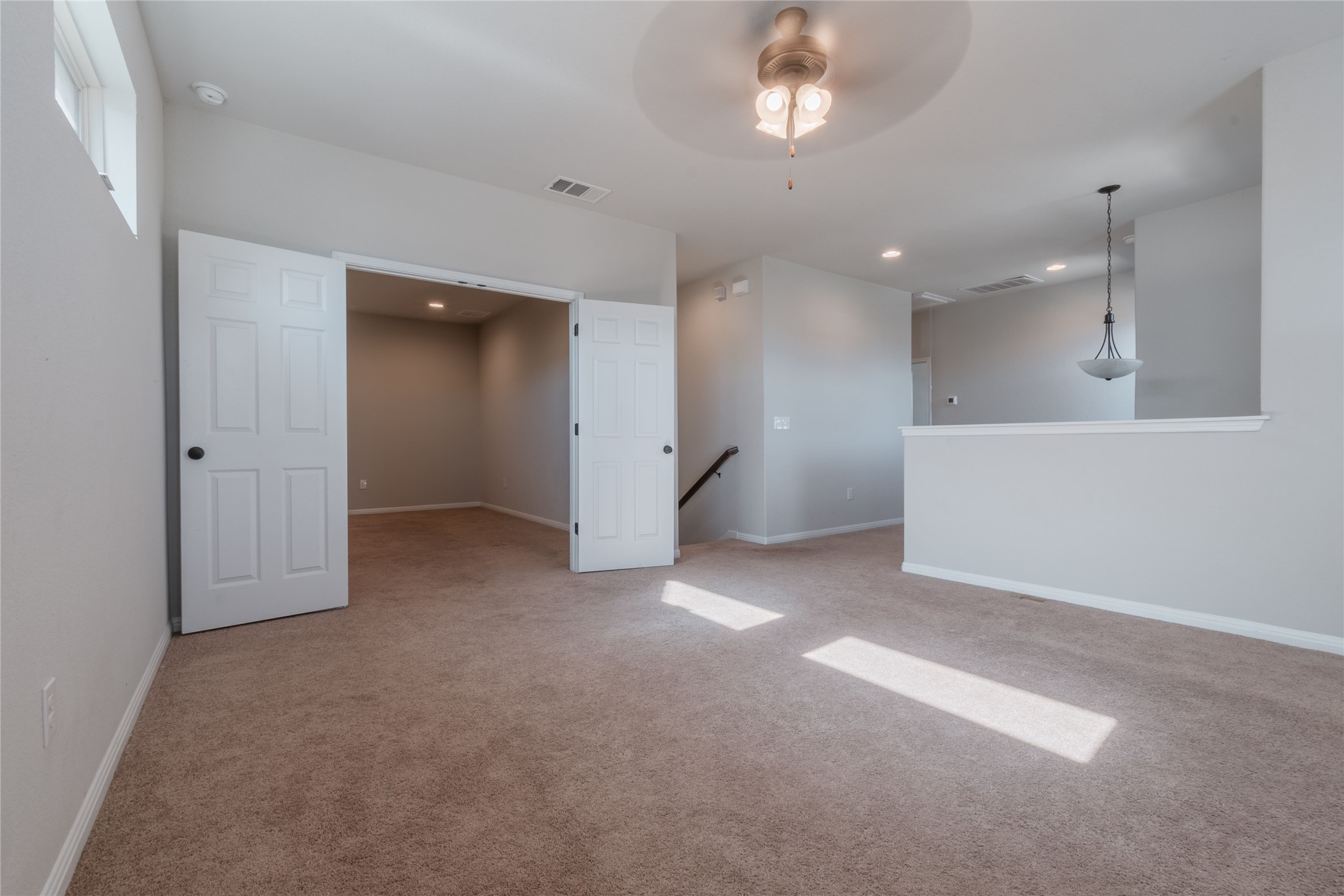 3810 Brushy Creek Road, Unit 77 Cedar Park, TX 78613 - Photo 25 of 33 an empty room with a kitchen and a chandelier fan