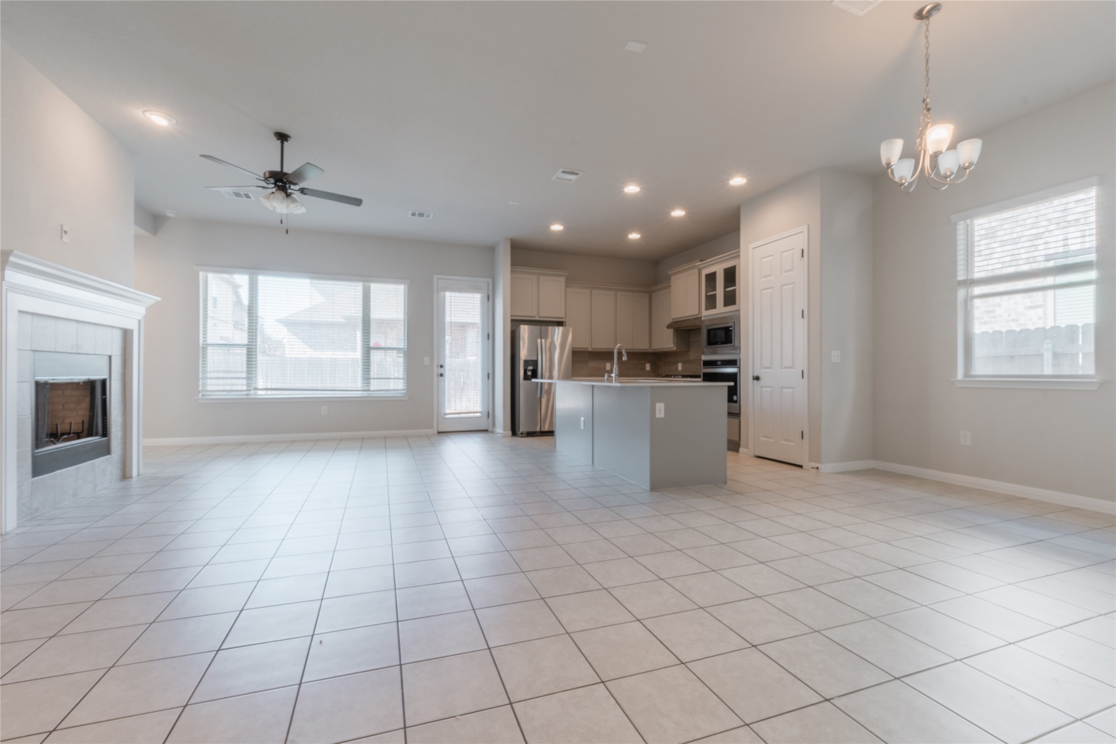 3810 Brushy Creek Road, Unit 77 Cedar Park, TX 78613 - Photo 3 of 33 an empty room with windows and chandelier fan
