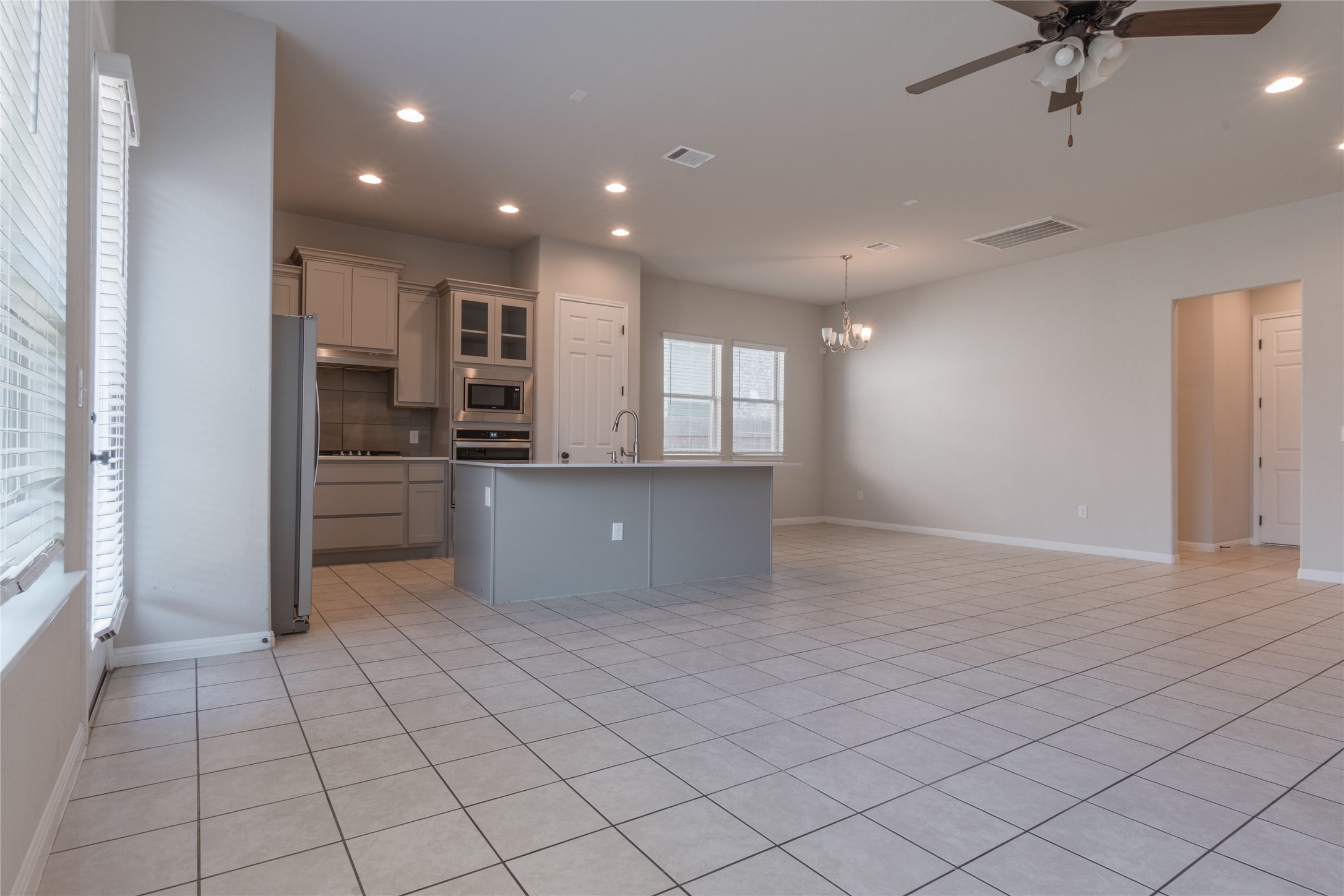 3810 Brushy Creek Road, Unit 77 Cedar Park, TX 78613 - Photo 6 of 33 a kitchen with stainless steel appliances kitchen island granite countertop a refrigerator and a sink