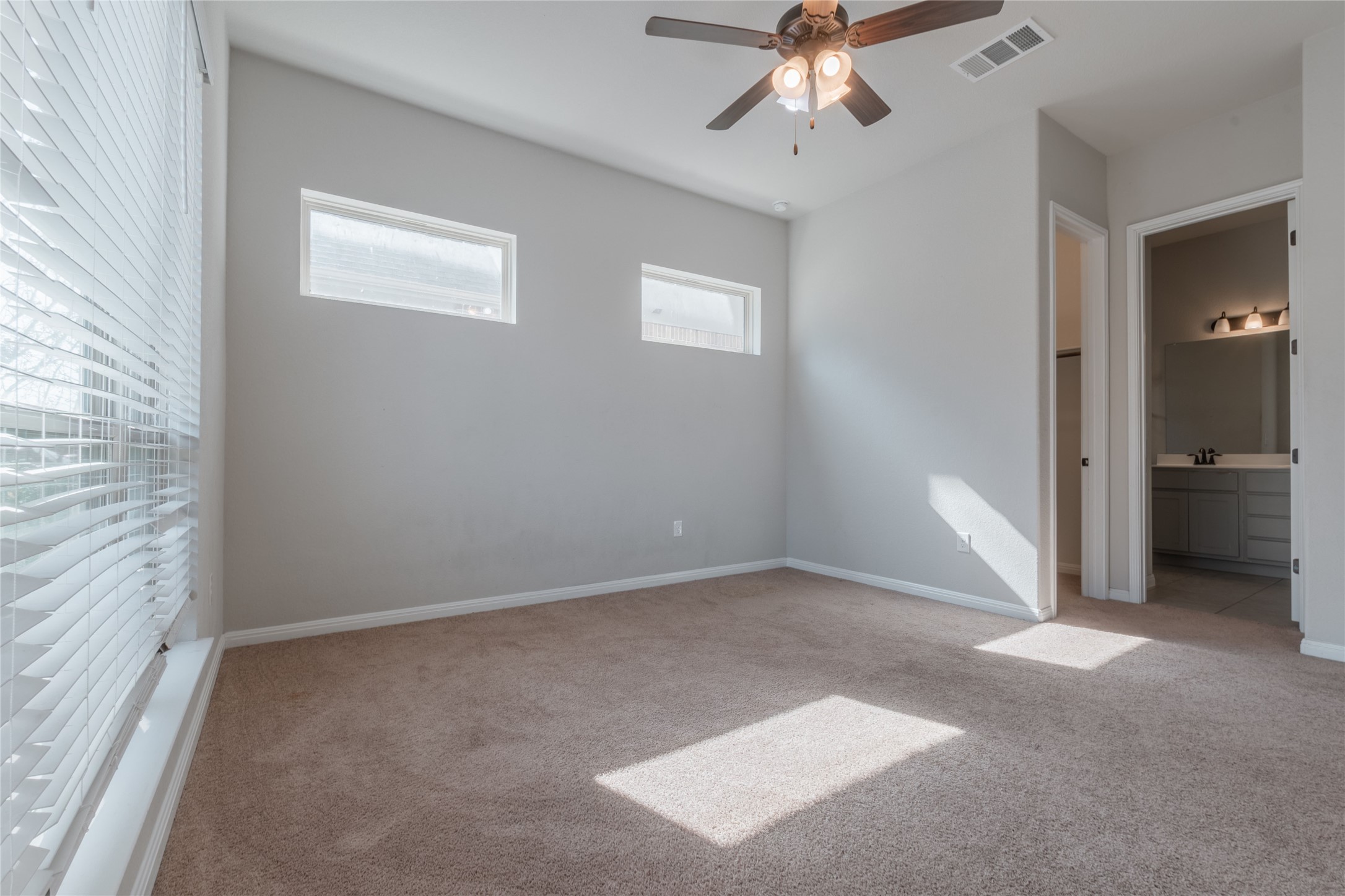 3810 Brushy Creek Road, Unit 77 Cedar Park, TX 78613 - Photo 7 of 33 an empty room with chandelier fan and windows