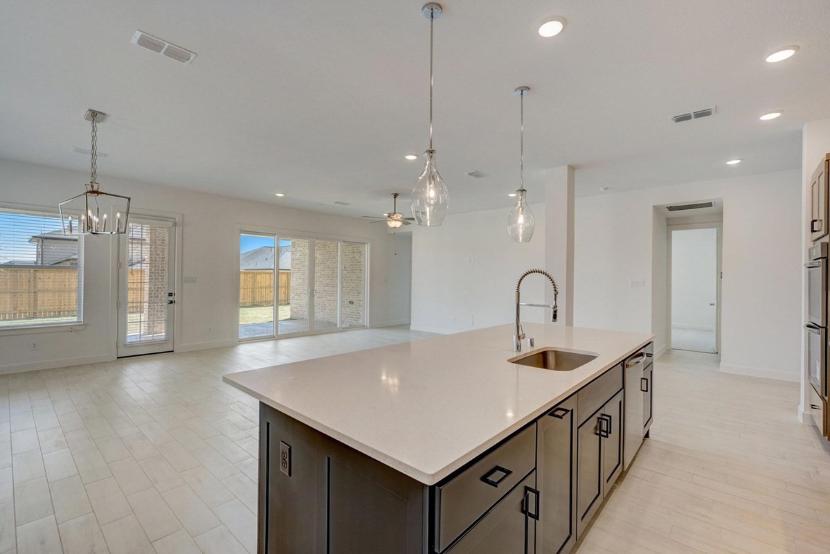 3408 Chestnut Colony Court Conroe, TX 77385 - Photo 4 of 22 a kitchen with a sink and chandelier