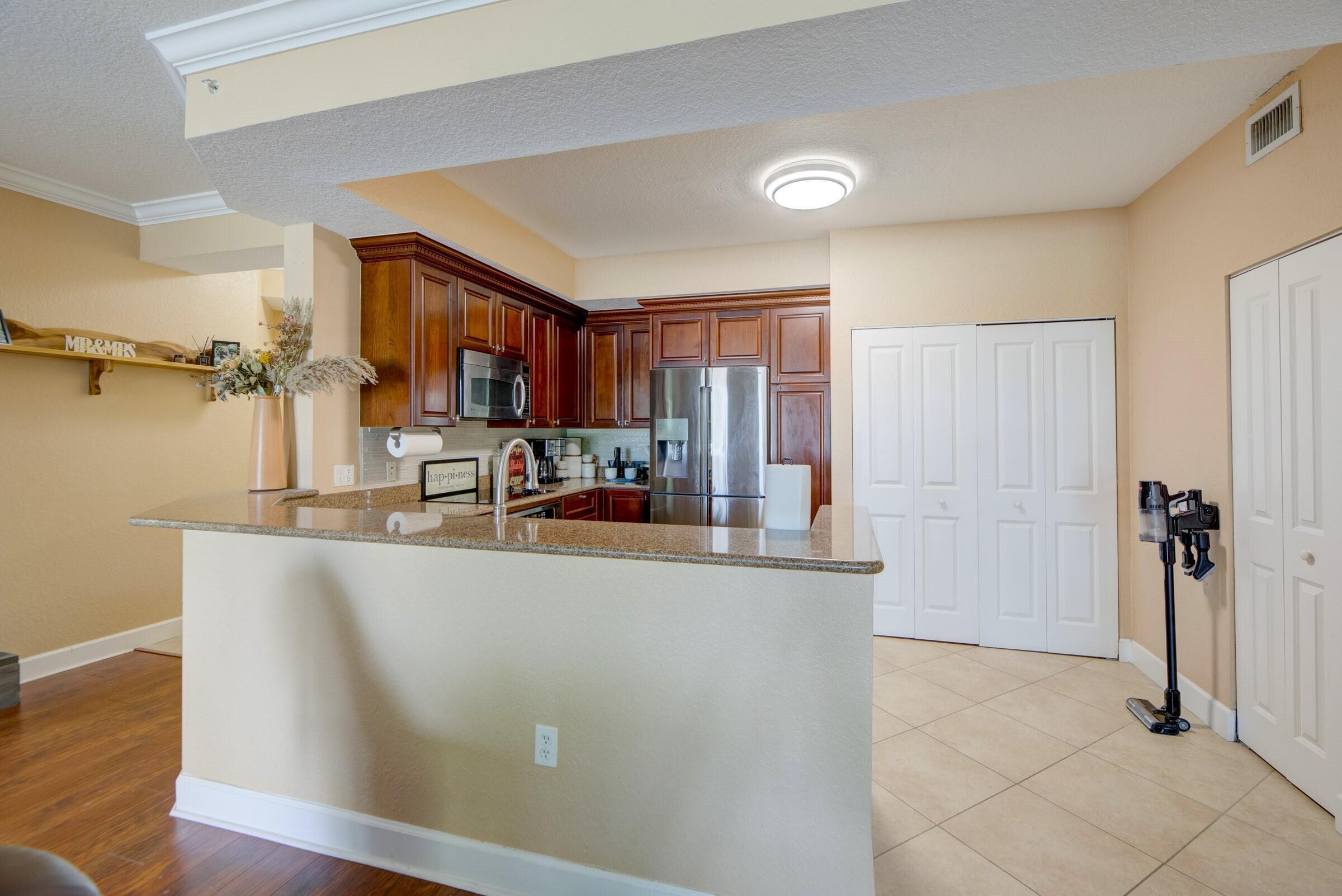 3107 Renaissance Way Boynton Beach, FL 33426 - Photo 12 of 37 a kitchen with stainless steel appliances granite countertop a refrigerator and a sink