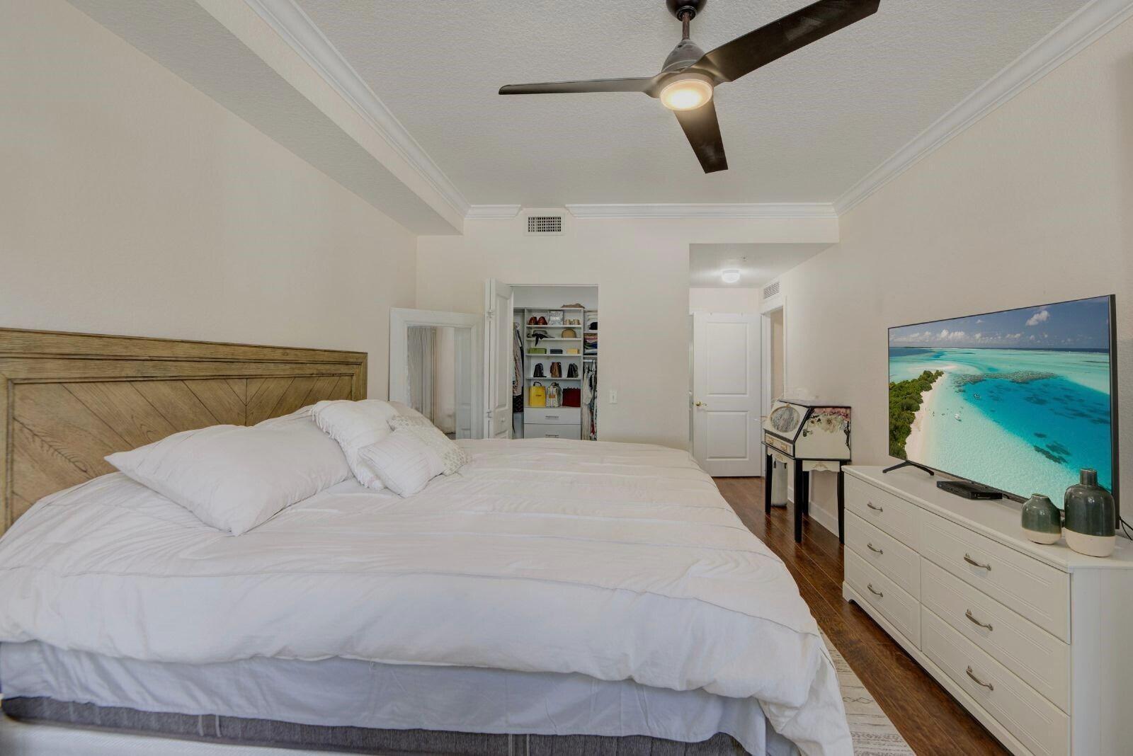 3107 Renaissance Way Boynton Beach, FL 33426 - Photo 15 of 37 a bedroom with a large bed and a flat tv screen on a dresser