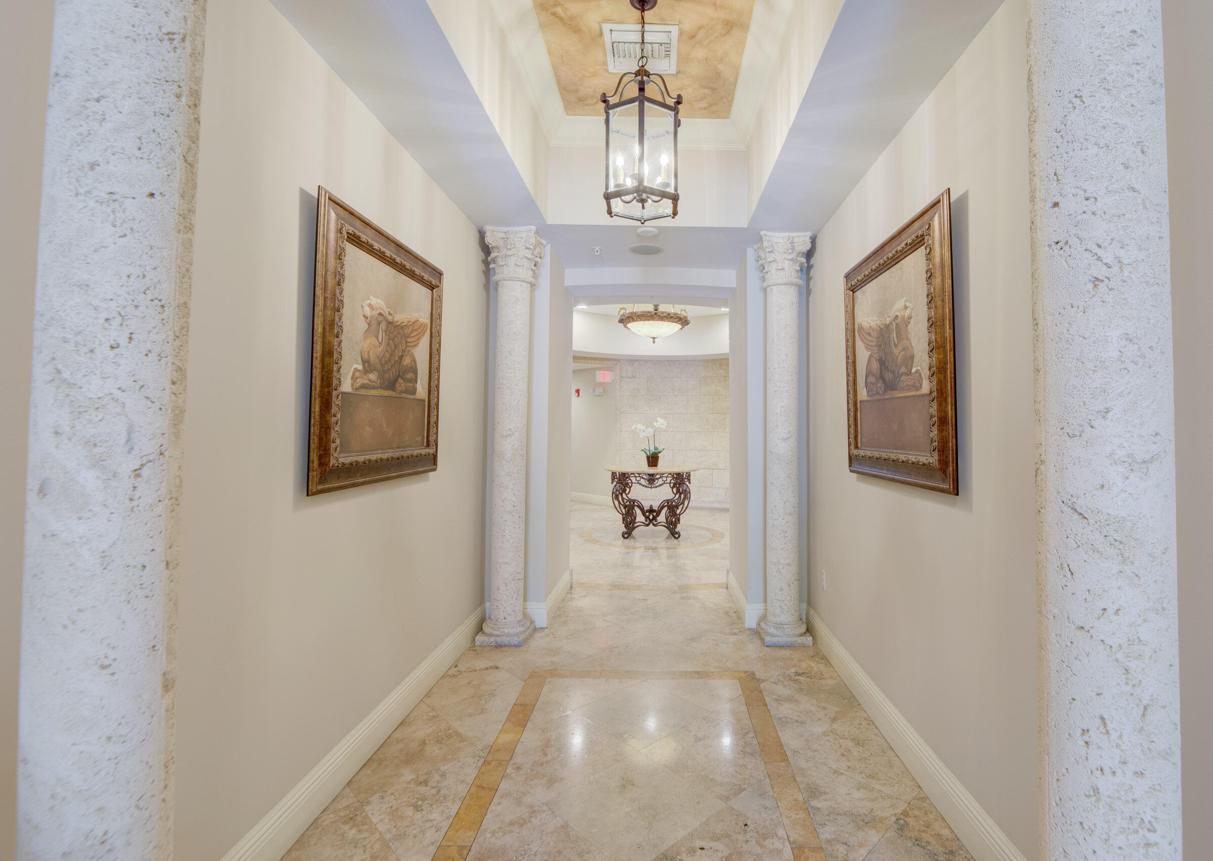 3107 Renaissance Way Boynton Beach, FL 33426 - Photo 30 of 37 a view of a hallway with a chandelier