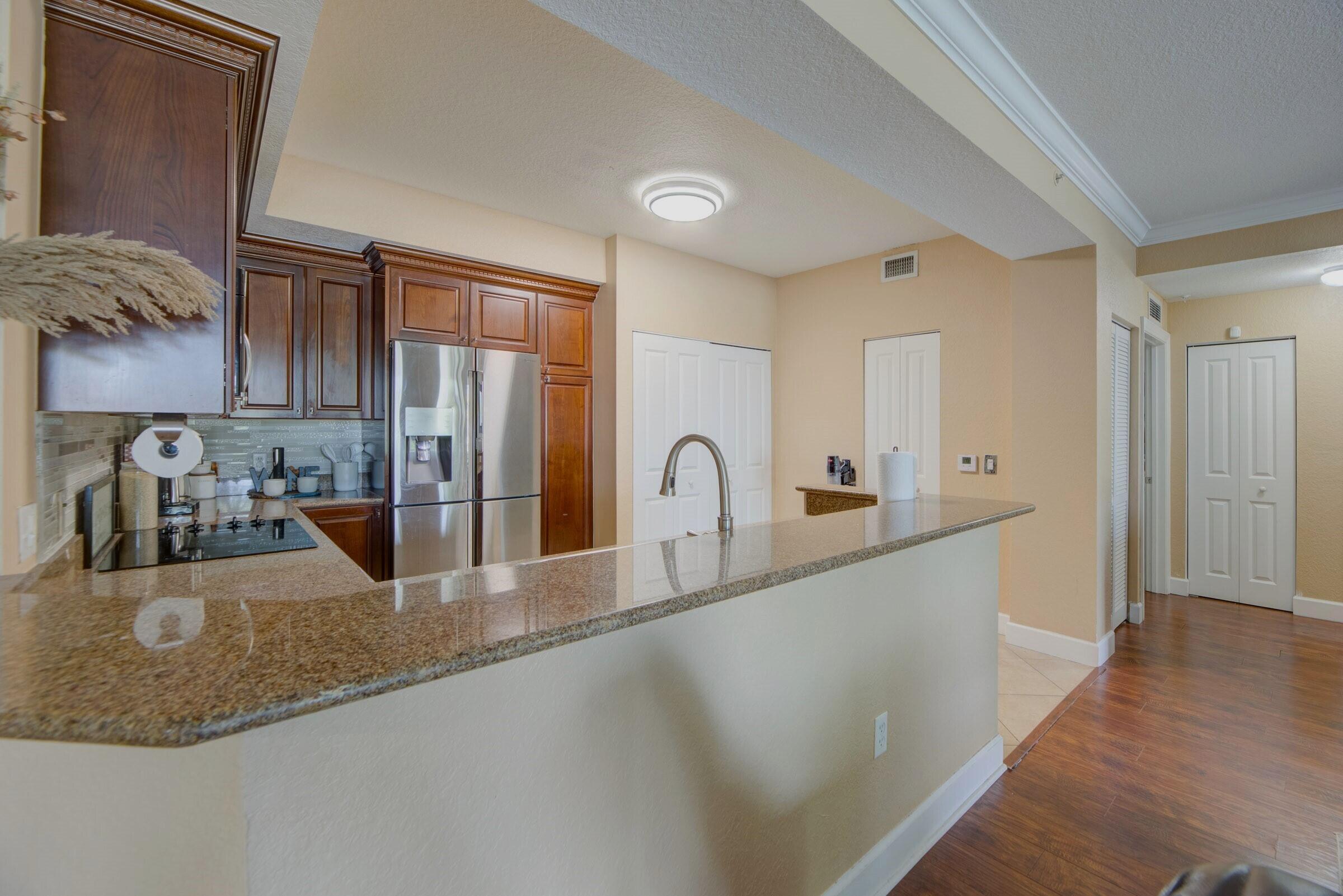 3107 Renaissance Way Boynton Beach, FL 33426 - Photo 9 of 37 a large kitchen with granite countertop a sink a stove and cabinets
