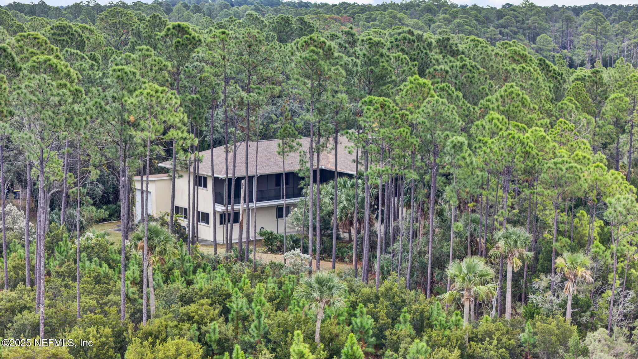 a view of a house with a small yard and wooden fence