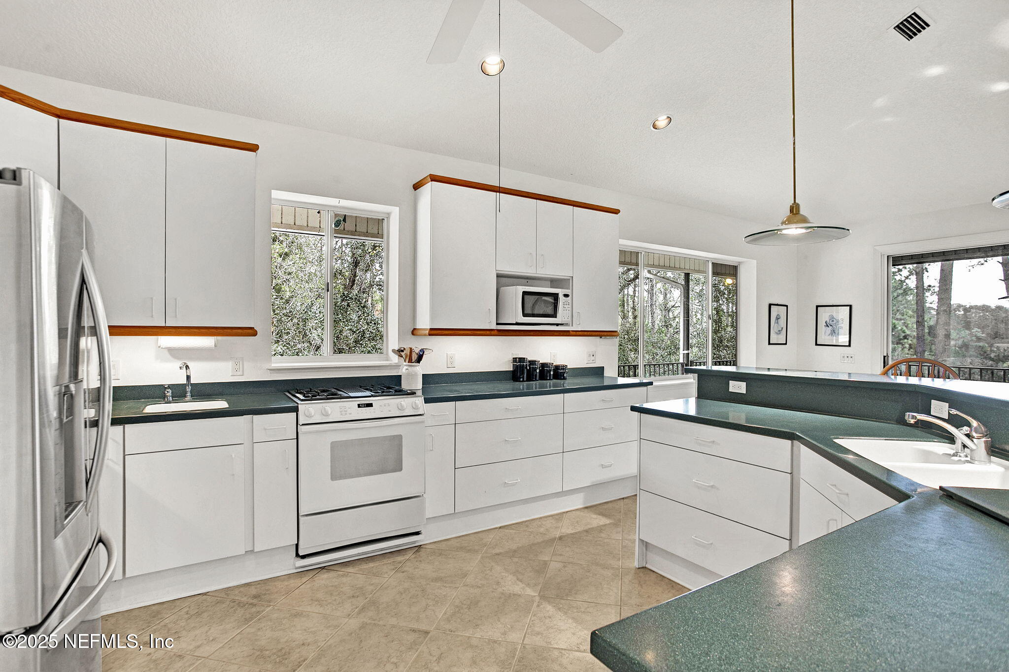 15501 Waterville Road Jacksonville, FL 32226 - Photo 6 of 24 a large white kitchen with stainless steel appliances granite countertop a sink window and cabinets